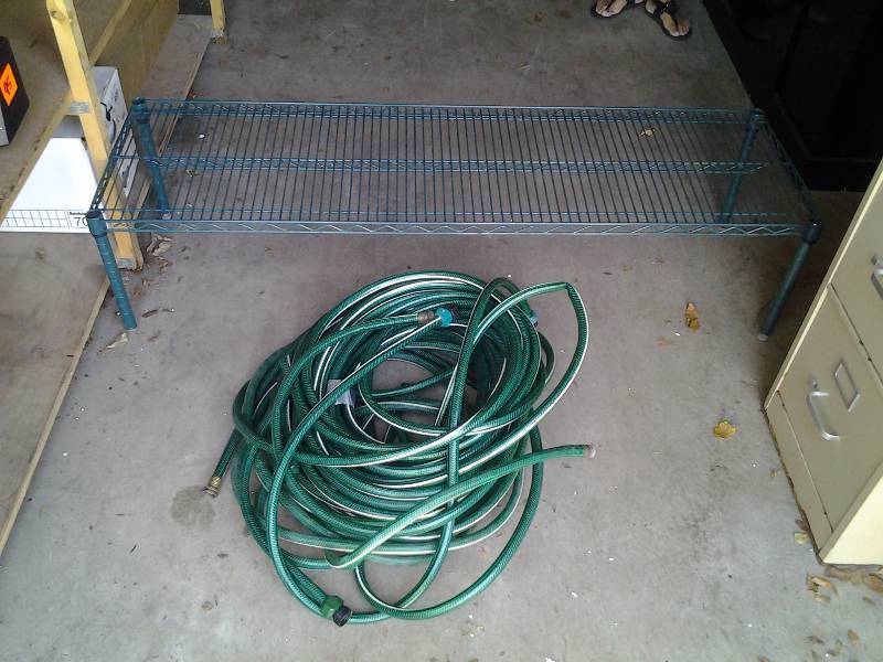 lot 96 image: 5 Foot Wire Shelf, Large Roll Of Garden Hose