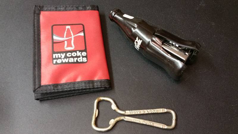 lot 28 image: Coca-Cola Wallet, Stapler, and Vintage Bottle Cap Opener