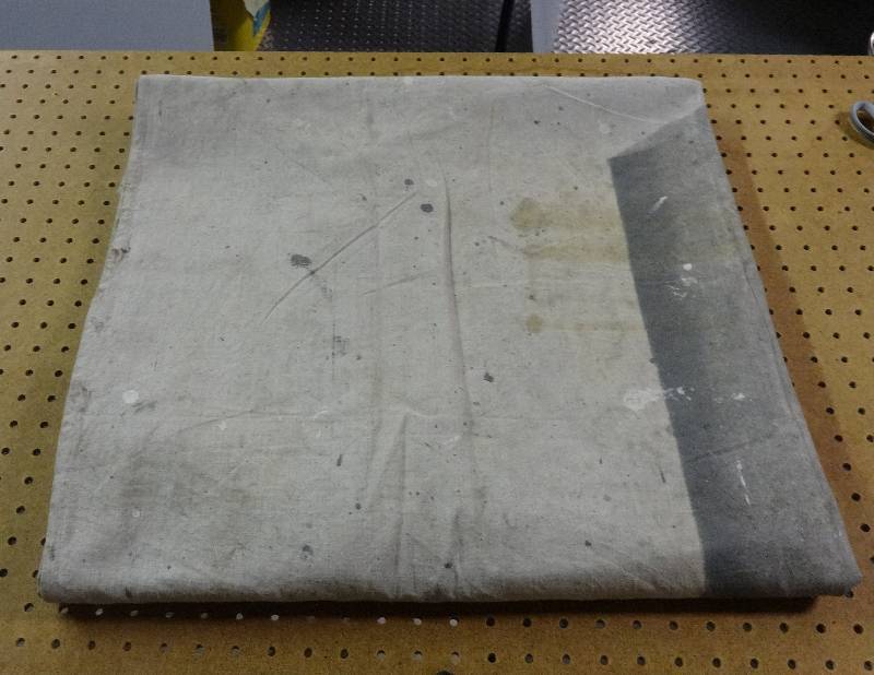 lot 121 image: 2 used painting tarps. The large one has a few small holes. Approx 3.6ftx13ft and 13.6ft x 22ft