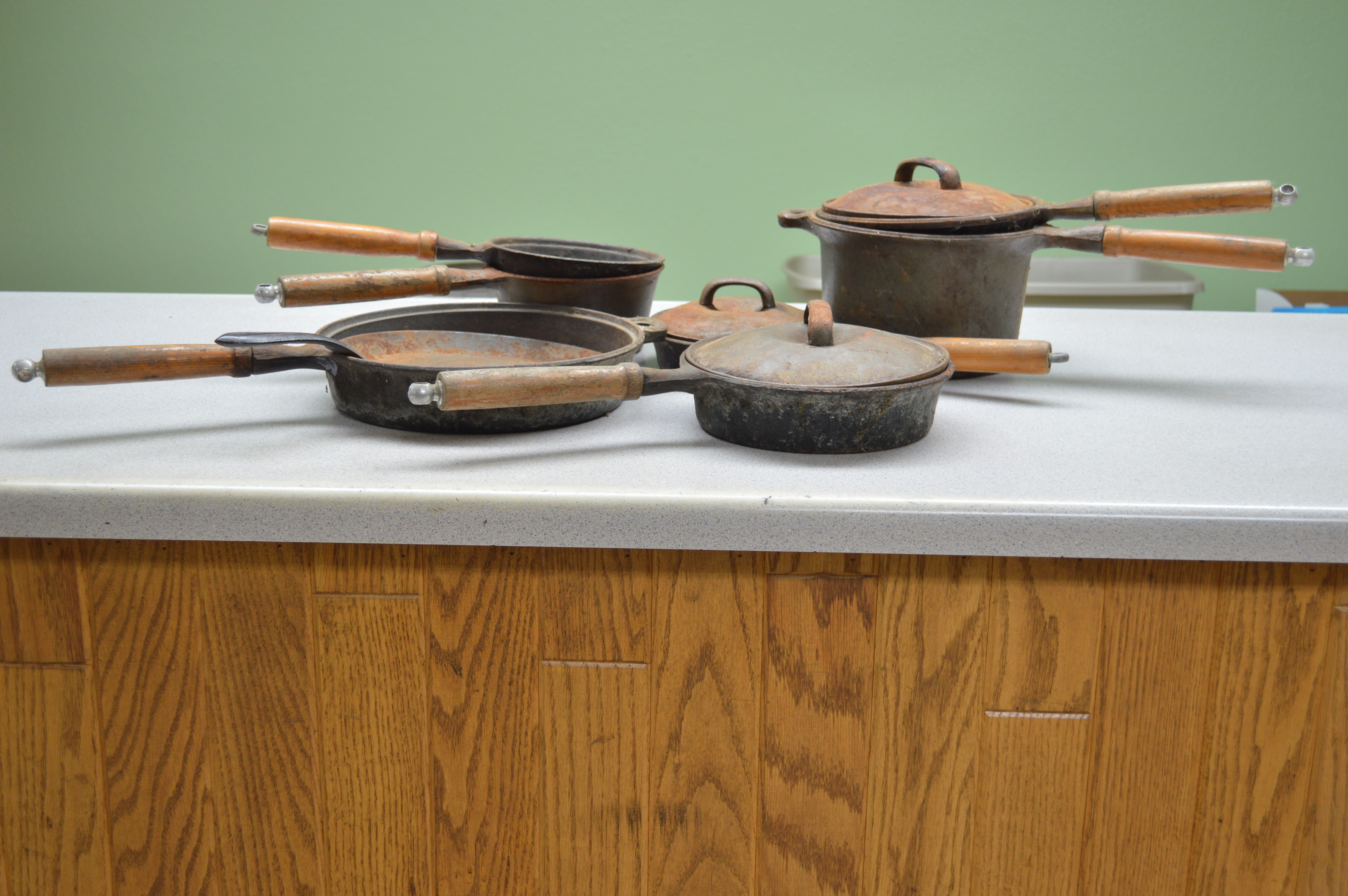 lot 38 image: 8- Cast Iron frying pans and pots with wooden handles
