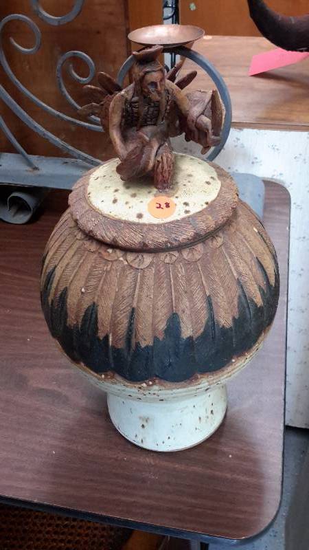 Handcrafted clay vase with feather design