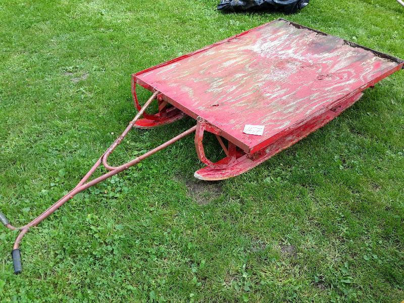 lot 157 image: Home made Sled.. Metal frame but wood body and wood skiis.. Handle attaches.. This is heavy.. Probably best for pulling with snowmobile or 4 wheeler.