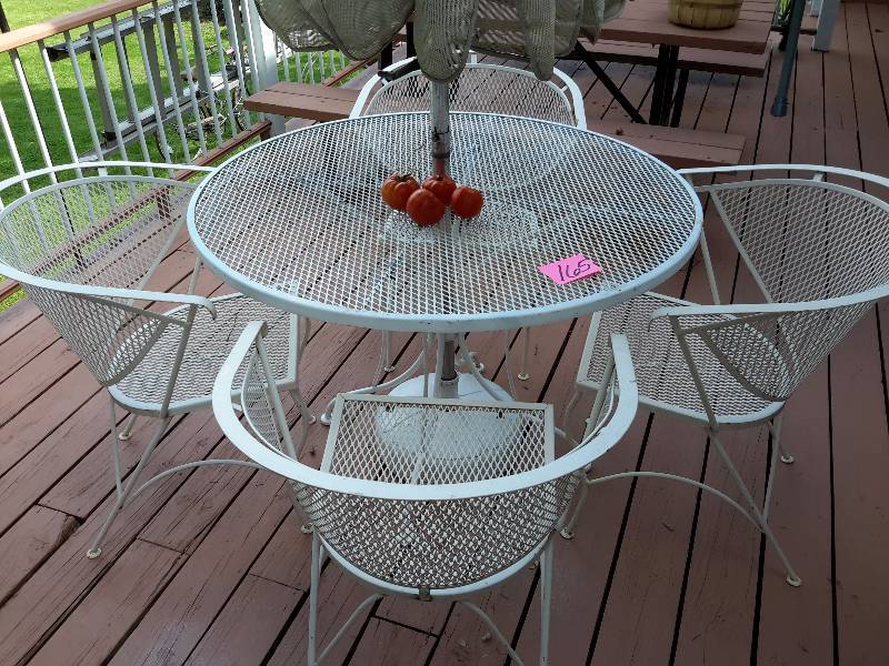 lot 165 image: Heavy Duty Metal Mesh Table and 4 Chairs.. Umbrella included.  Very good shape.  Bring your own loading help..