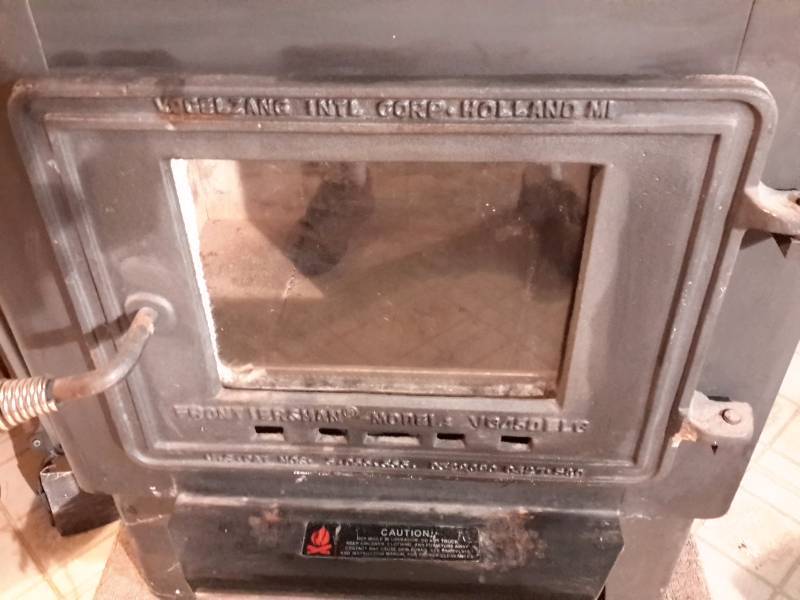 lot 187 image: KOGELZANG, INTL.. Holland Michigan.  Frontiersman, Heavy Cast Iron Wood stove with glass front.  36in x 18 in x 30 in h.    Excellent shape.