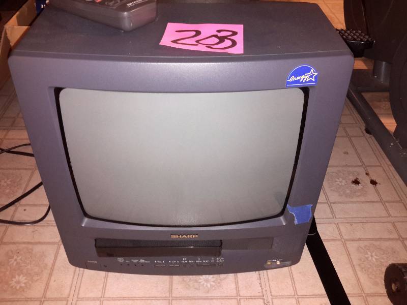 lot 203 image: SHARP, 13in TV and VCR.. Powers up and lights up.. Didnt try the VCR.
