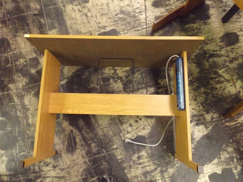 lot 658 image: Small wooden desk with electrical strip