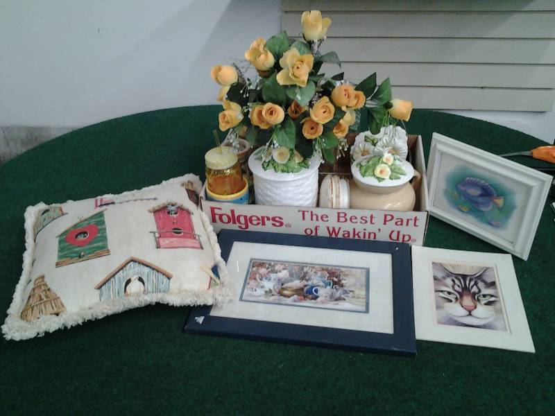 lot 14 image: Birdhouse Pillow, Teapot Picture, Yellow Floral Centerpiece, Canisters, Wire Basket, Amber Glass, Misc