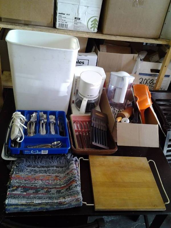 lot 28 image: Large Lot Of Kitchen Related Utensils, Flatware, Rug, Cutting Board, Trash Can, Coffee Maker, Electric Knives, Steak Knives