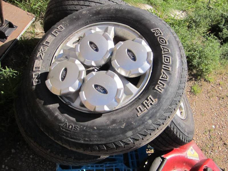 4 tires and rims off a Ford Escape,...
