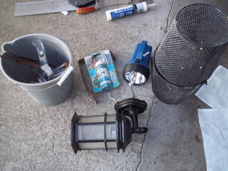 Outdoor light, flashlight, pail with large nails and minnow trap