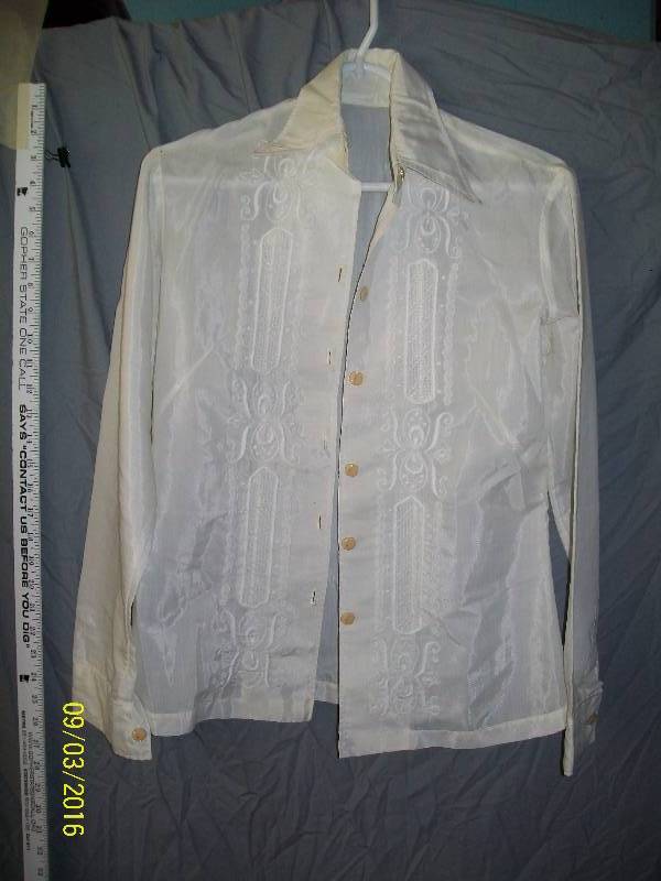 lot 20 image: Adult CostumeWhite-ish ShirtBlouse with stitched design. Unknown Size. No Tag. Button down Front.