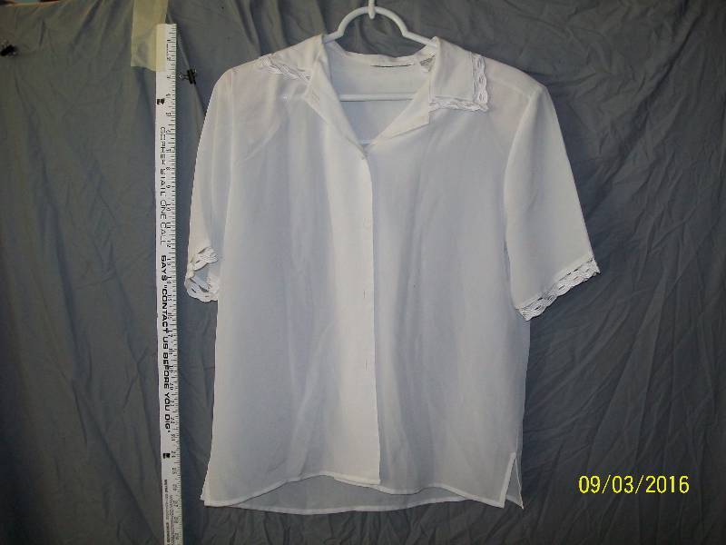 lot 23 image: Adult CostumePolyester White-ish ShirtBlouse. Unknown Size. TagPolyester. Cloth Button down Front.