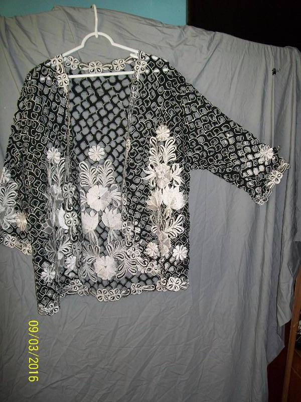 lot 28 image: Adult CostumeBlack with White-ish Floral Design Jacket Cover. Unknown Size. No Tag