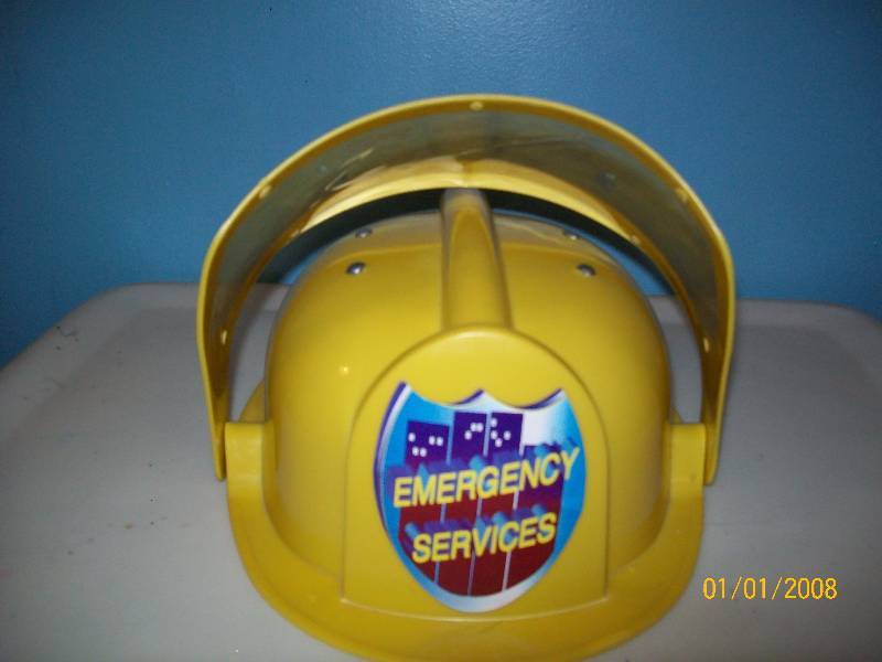 lot 77 image: Child Costume Bright Yellow Plastic Emergency Services Hat with moveable front clear face protector.