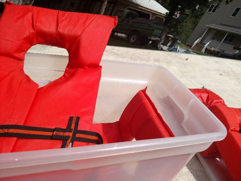 Lot of life jackets, rubbermaid container included