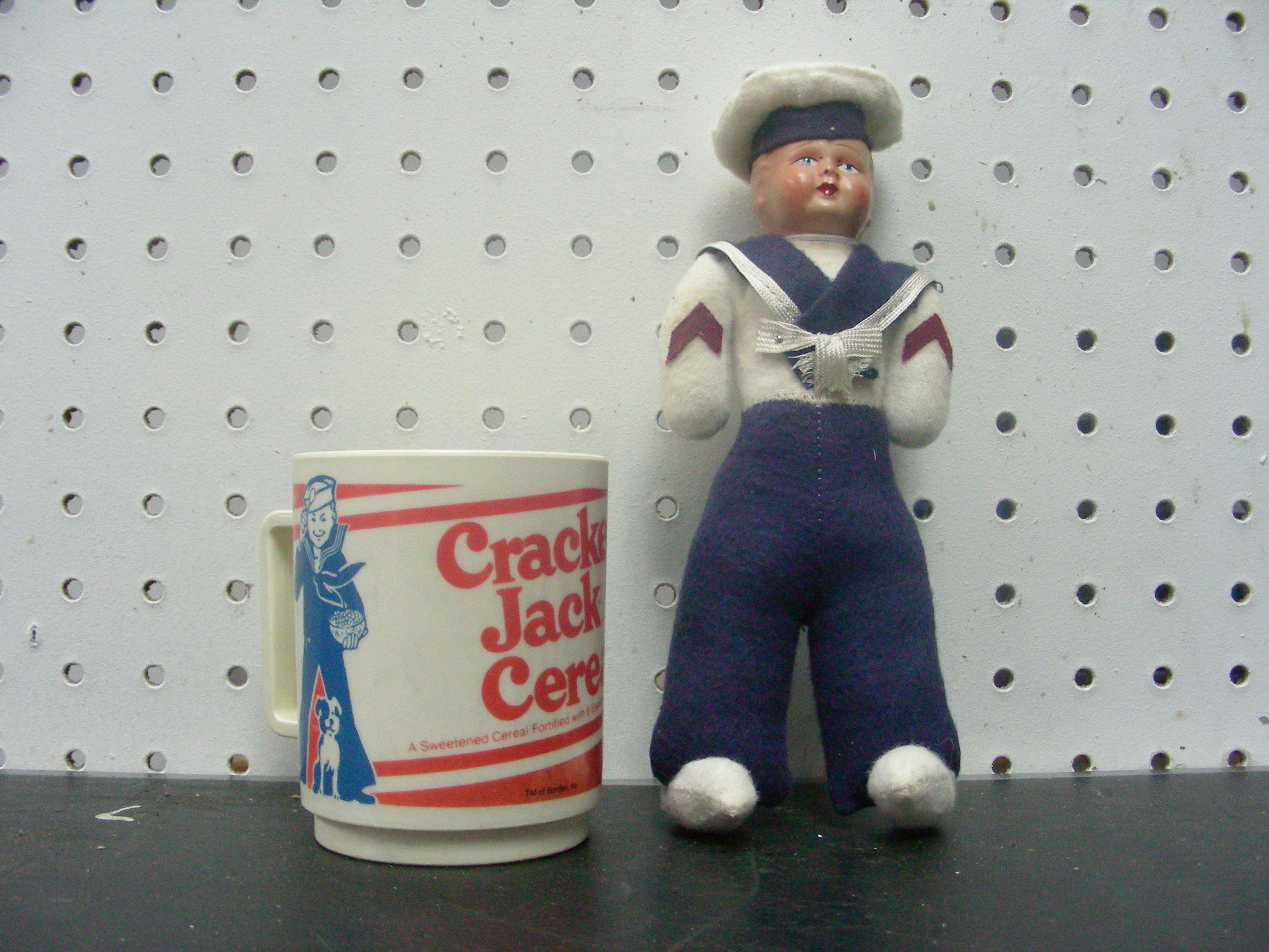lot 26 image: Vintage Cracker Jack Sailor Doll, and Cup