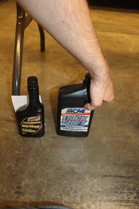 lot 27 image: 1-Pint power steering fluid, 1-Quart B & M transmission fluid.