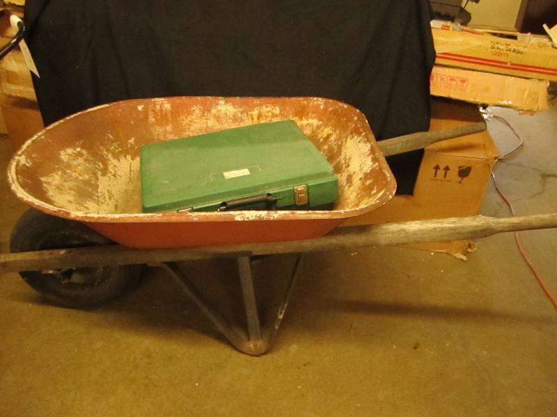 Wheel barrow with latching storage ...