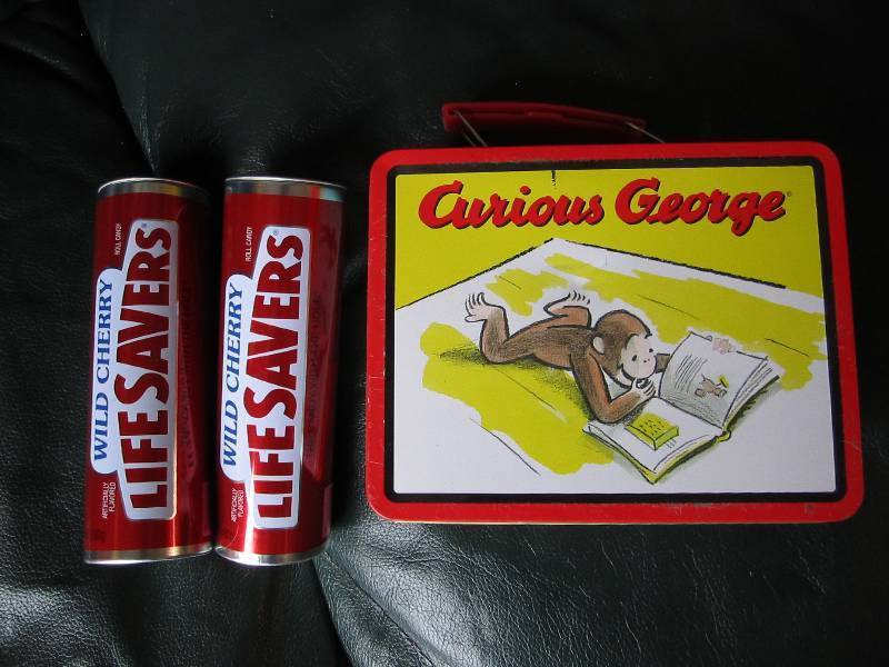 lot 24 image: Curious George and Life Savers cans...