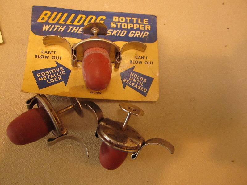 lot 107 image: Vintage Bulldog bottle stoppers...