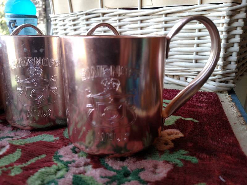 lot 17 image: Set of Smirnoff copper cups. (4 cups)