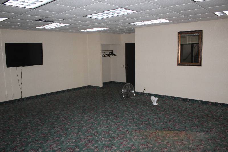 lot 187 image: Lot of Furniture Including Decorative Wall Mount Mirror, Paper Dispenser, Soap Dispenser, Ice Box, Table, Fan, Philips 55in. Flat Screen Wall Mount TV