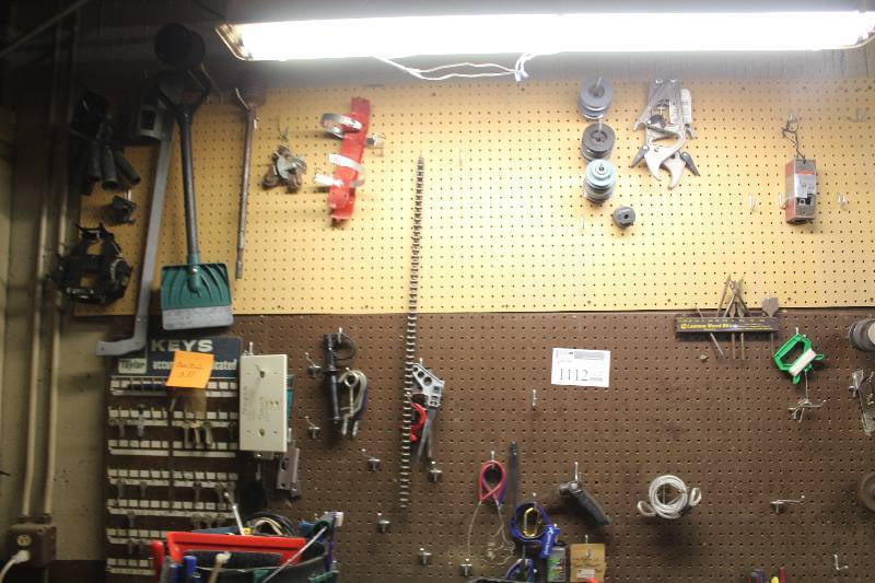 lot 1112 image: Wall Lot of Tools Including Pipes, Clamps, Castors, Key Rack, Chain Wrench, And More