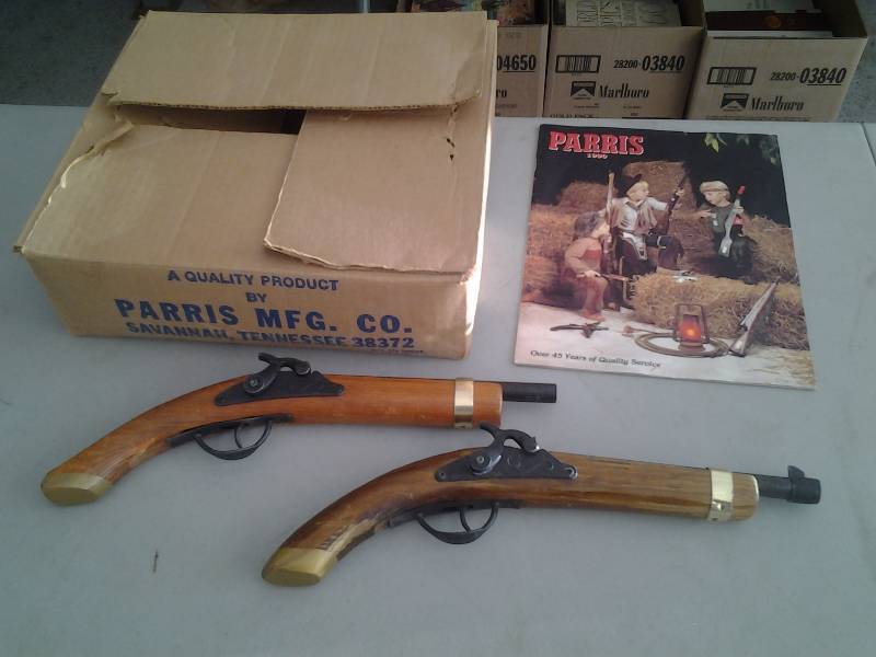 lot 15 image: 2-Toy Pistols By Parris Guns, 1-Book, 1-Box