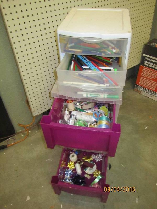 2 plastic storage drawers filled wi...