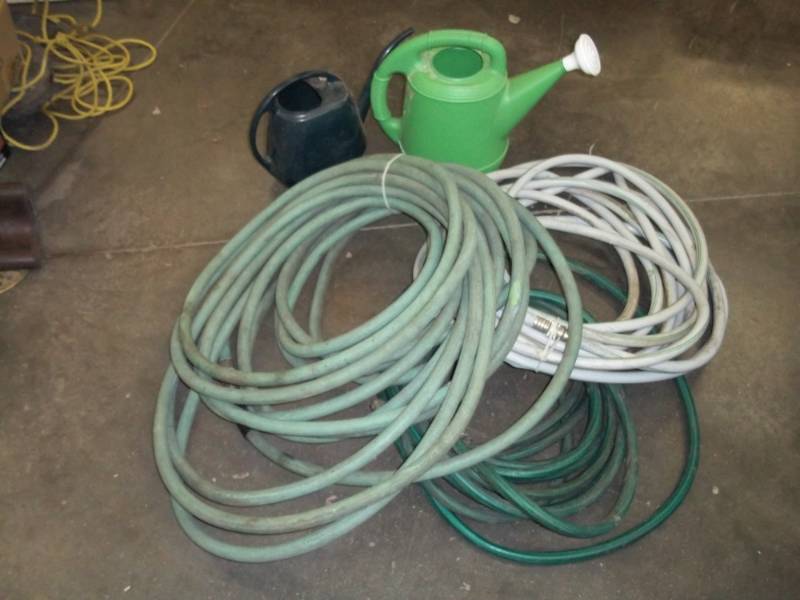 3 Garden hoses and 2 watering cans