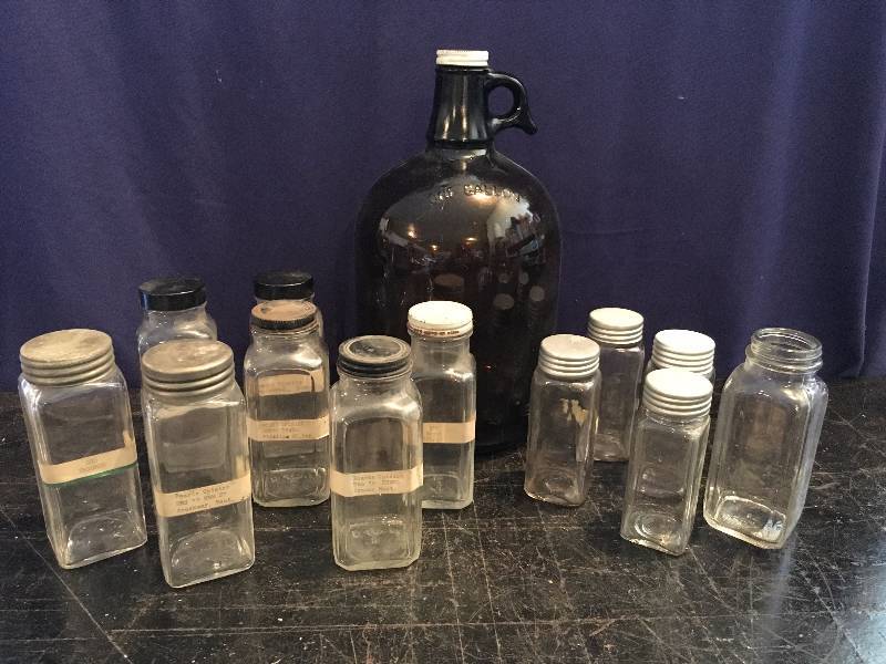 One Gallon Brown Glass Jug & Several Small Glass Jars