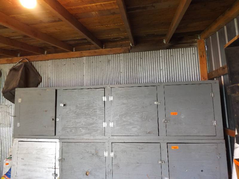 lot 134 image: Gray wood 4 door cabinet, top one o...