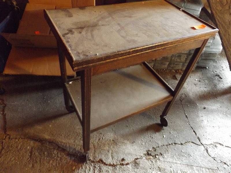 lot 247 image: Rolling vintage wood table opens to...