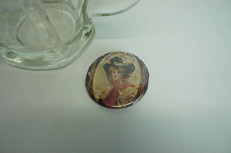 lot 78 image: Olympia beer serving pitcher and button