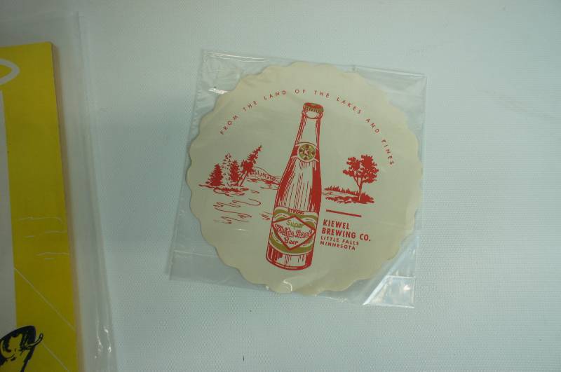 lot 89 image: Kiewel cookbook, napkin & white seal sign