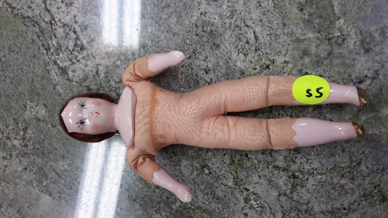 Vintage doll with hard plastic or ceramic head, hands and feet