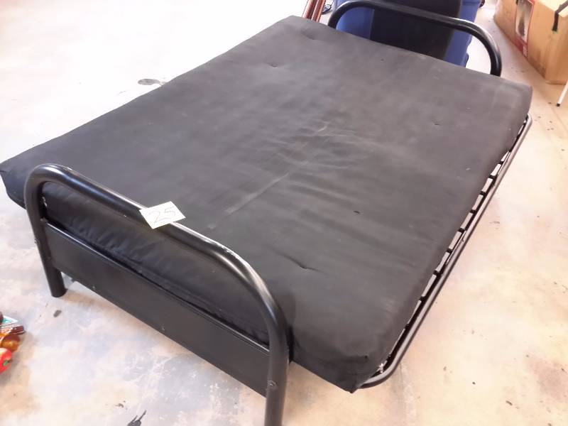 lot 25 image: Futon, metal frame.. Cushion looks in good shape.. Could use  alittle cleaning.. Great for a college room or cabin.