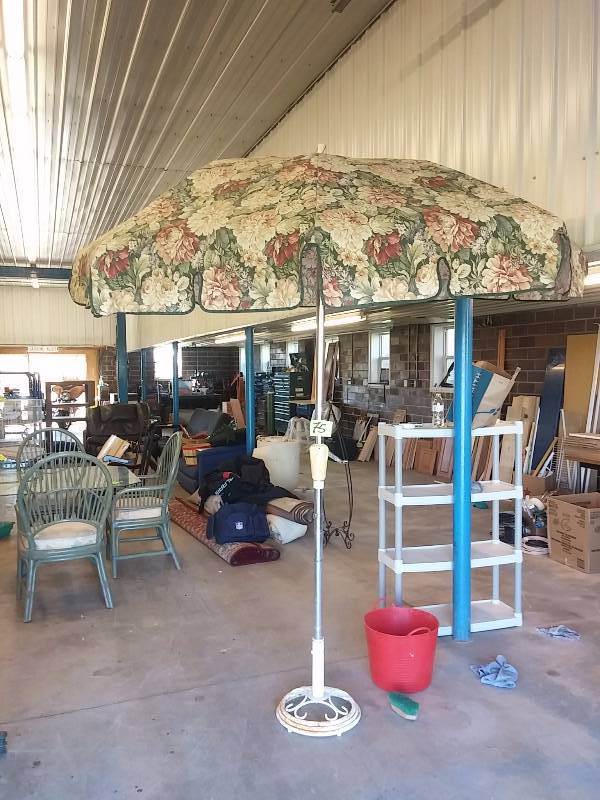 lot 75 image: Patio Umbrella and stand. Wrought Iron Stand