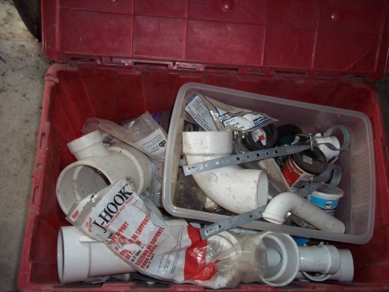 Storage tote with plumbing supplies