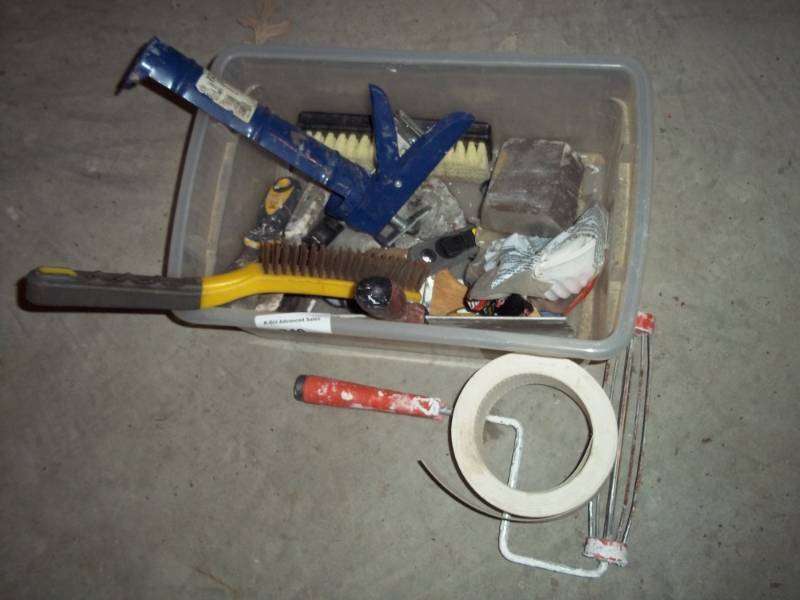 Caulking gun, wire brush, sheet rock tool and tub