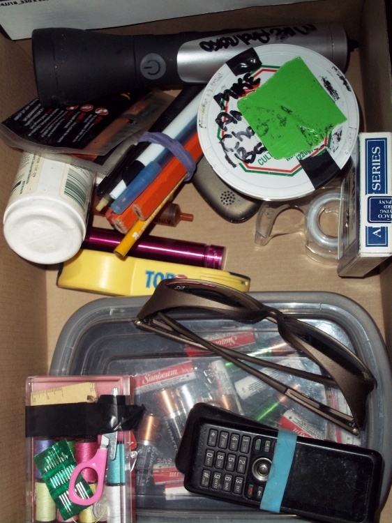sew kit, batteries, cards and flashlight