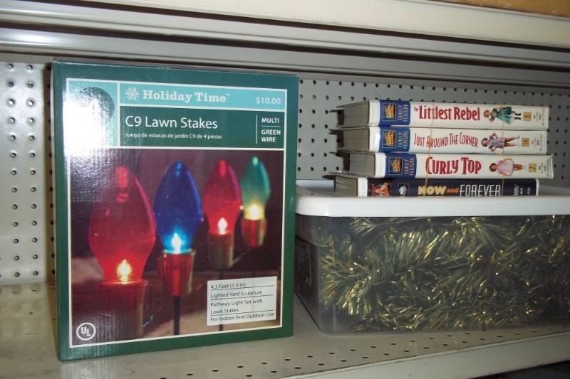 lot 113 image: Christmas Lights & Garland, Storage tote, Shirley Temple VHS tapes