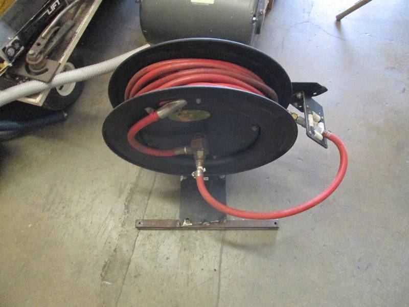 lot 28 image: air hose and reel with mounting bra...