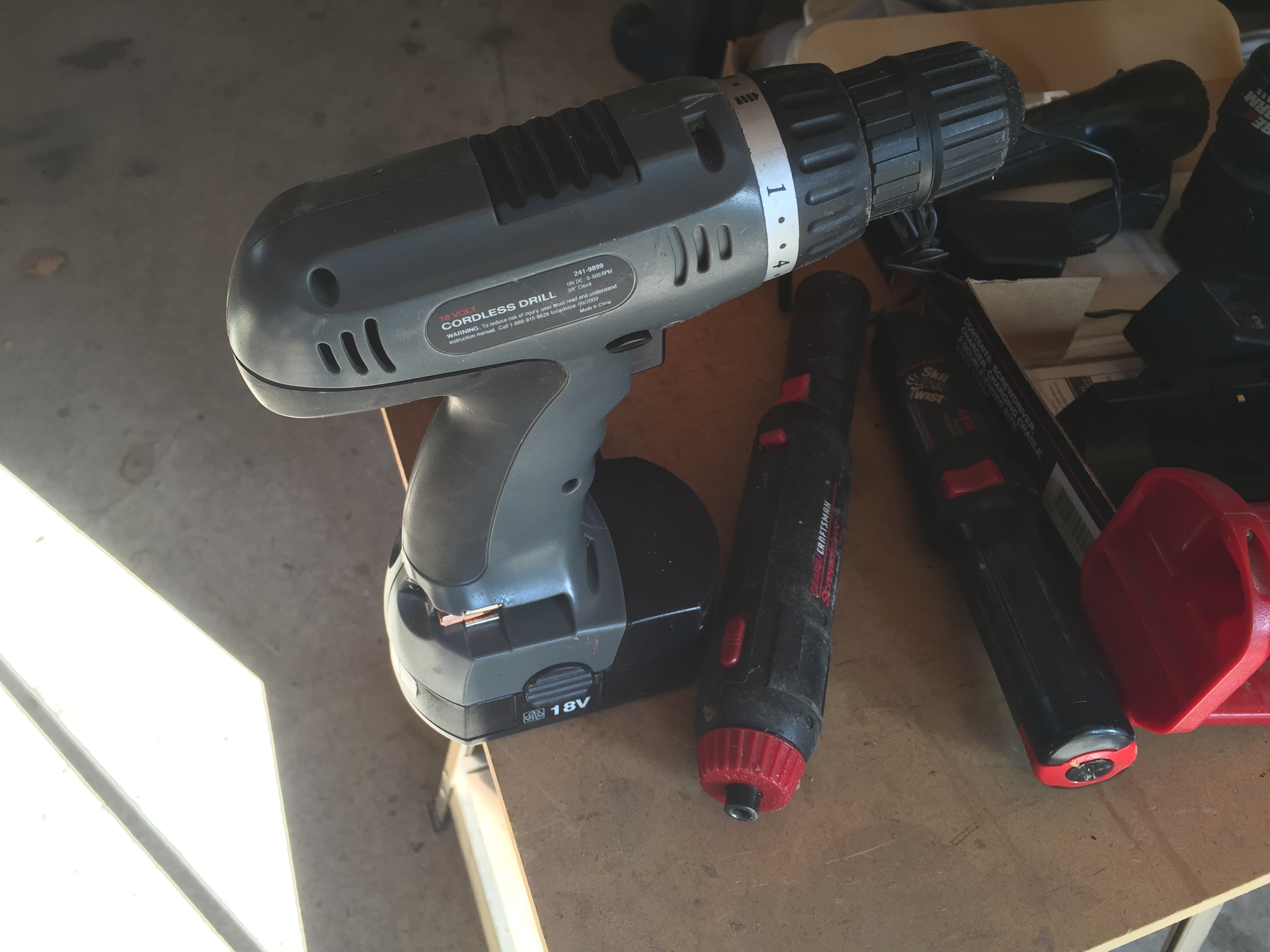 lot 19 image: Box of misc cordless tools with missing parts.