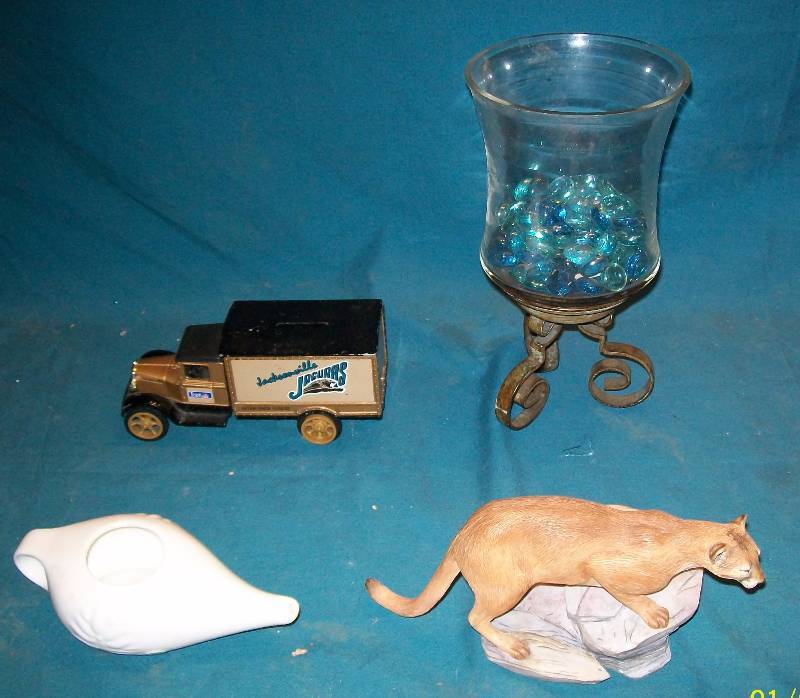lot 57 image: Decorations Mountain Lion Statue, Candle Holder, Neti Pot, Jacksonville Jaguars Truck Bank