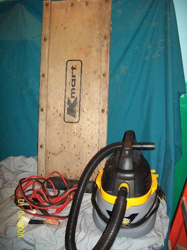 lot 83 image: K-Mart Mechanic Car Creeper & Jumper Cables & Stinger Model# WD 20250 Wet & Dry Vac with Hose