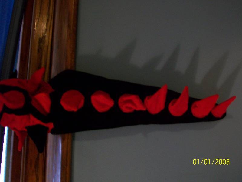 lot 72 image: Child Costume Cap Child Skull Cap with spikes down long tail. Resembles Dragon or Dinosaur.