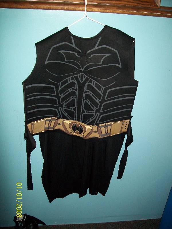 lot 61 image: Child Costume Batman. Batman Chest Piece ties in back with attached Cape & Plastic Face Mask.