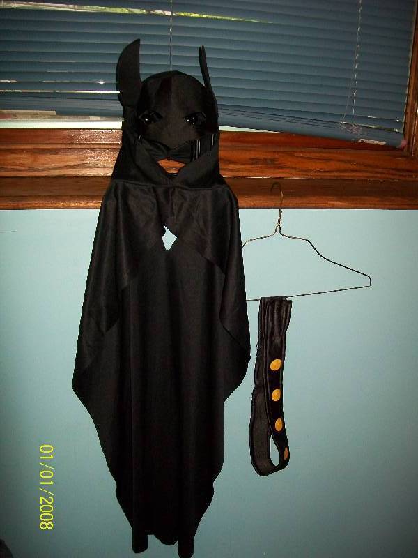 lot 63 image: Child Costume Batman. Unknown Size. Seems Small. Cape with attached head cover & Mask.