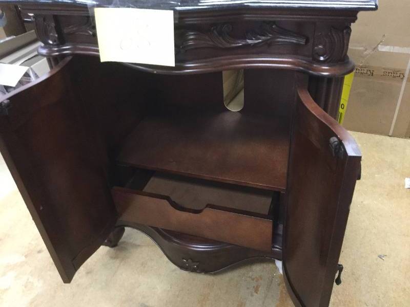 lot 68 image: Estates 31 in. Vanity in Rich Mahogany with Granite Vanity Top in Black- slight damage on bottom of legs but overall in very good condition Retails for $680